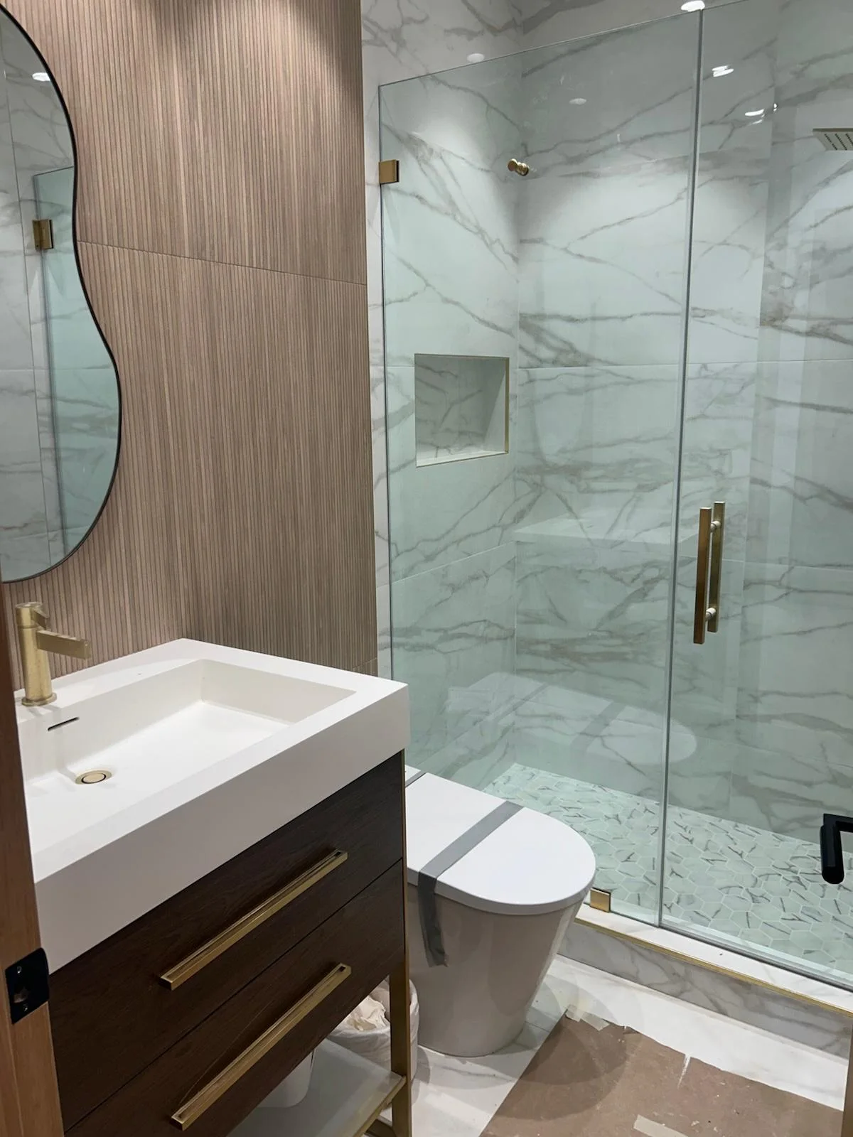 Marble bathroom and glass shower detailed after a remodel